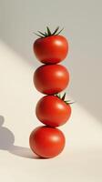 A stack of tomato fruit balancing on top with pink solid background photo