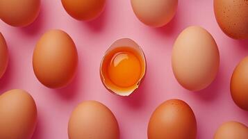 Egg pattern with a distinct anomaly of crushed shell showing egg yolk solid background photo