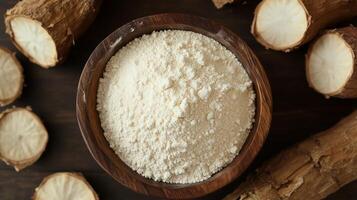 Cassava flour on brown wooden bowl and some fruits for baking, gluten free copy space photo