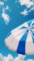 Umbrella blue and white beach for sunburn protection and blue sky bottom view photo