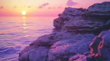 Sunset violet sky on horizon line in ocean rock edge photo