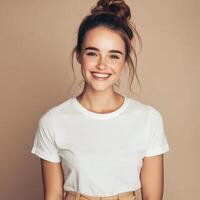 Young woman with a joyful smile posing against a neutral background photo