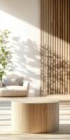 Sunlit modern living room with wooden table and greenery in background photo