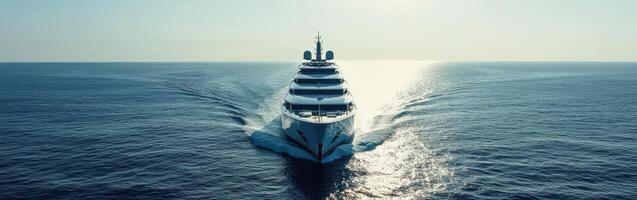 Luxurious yacht navigating calm waters under a bright, clear sky photo