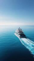 A luxurious yacht cruising through the serene blue waters at sunset photo