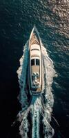 Aerial view of a luxurious yacht gliding through clear blue waters photo