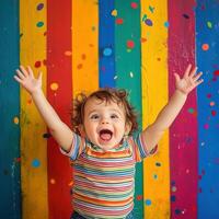 Excited toddler cheering joyfully with colorful confetti backdrop photo