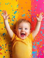 Cheerful toddler excitedly celebrating with colorful confetti on the ground photo