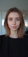 Young professional posing at the office during daytime with natural light photo