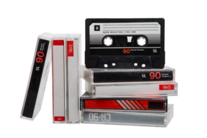 A stack of audio cassettes. Close-up of an audio cassette with a sticker without text. Cassettes for audio recordings and music. Analog storage medium. png