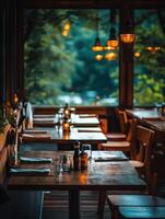 Cozy and empty restaurant interior with warm lighting during twilight photo