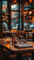 Cozy empty restaurant with warm lighting and elegant table settings photo
