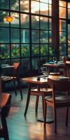 Cozy empty restaurant with wooden tables and natural light at sunset photo