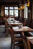 Cozy empty restaurant interior with wooden tables and chairs at dusk photo