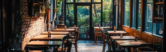 Cozy empty restaurant with wooden tables and large windows in the evening photo