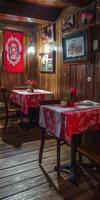 Cozy interior of an empty rustic restaurant with charming red tablecloths photo