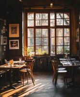 Cozy empty restaurant with sunlight streaming through large windows photo