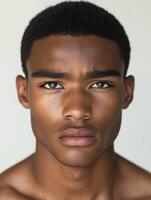 Athletic man with striking features poses against a neutral background photo