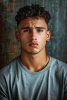 Handsome athletic man with curly hair posed against a textured backdrop photo