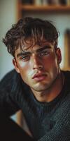An athletic man with tousled dark hair gazes confidently at the viewer photo
