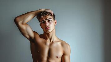 Athletic handsome man posing indoors with a confident expression photo