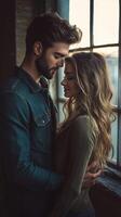 Young couple embraces by a large window during sunset in an urban setting photo
