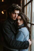 Two young adults embracing by a window in an urban setting photo