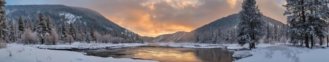 Snow-covered river valley at sunset with towering mountains in view photo