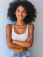 Woman with curly hair posing confidently against a light background photo