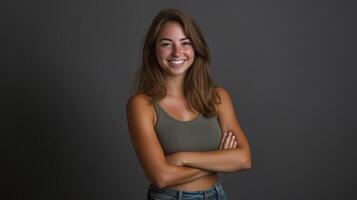 Young woman smiling confidently with arms crossed in a studio setting photo