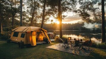 Camping tent glowing in the light of the setting sun by the lake photo