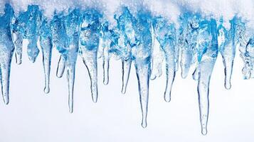 Sharp icicles hanging from roof covered with snow melting in springtime photo