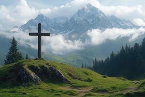 Wooden cross standing on a green hill with mountains in background photo