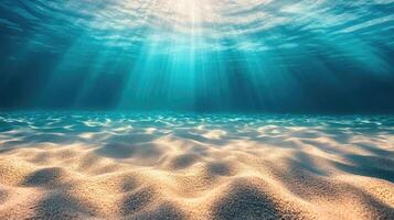 Sunlight shining through the surface of a clear ocean onto a sandy bottom photo