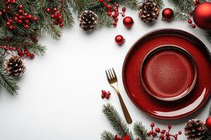 Beautiful christmas table setting with red plates, candles and decorations photo