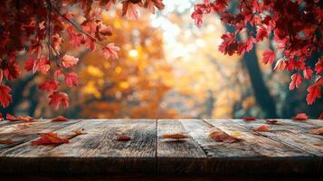 Red maple leaves falling on wooden table during autumn photo