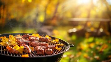 Enjoy a sunny autumn day savoring grilled meats at a backyard barbecue, surrounded by vibrant fall leaves. This setting is perfect for outdoor cooking and gatherings with family and friends photo