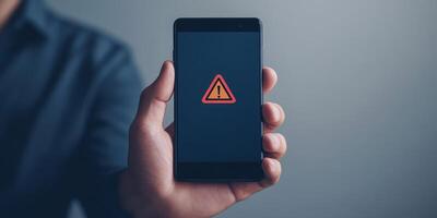The image shows a warning sign on a smartphone, highlighting risks in finance and investment. Its essential to remain alert to avoid pitfalls and ensure safety in this complex landscape photo