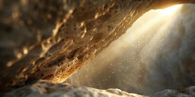Beautiful sunlit cave opening with dust particles illuminated by rays of sunlight creating a magical scene. photo