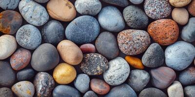 The riverbed is decorated with colorful, smooth pebbles creating a peaceful and relaxing atmosphere along the shoreline photo