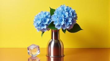 Metal Vase With Delicate Blue Hydrangeas on a Warm Yellow Background. With Transparent Crystal Beside The Vase photo