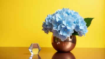 Metal Vase With Delicate Blue Hydrangeas on a Warm Yellow Background. With Transparent Crystal Beside The Vase photo