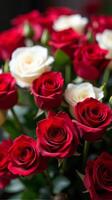 Dense Bouquet Featuring a Vibrant Contrast of Red and White Roses, With Lush Green Leaves Peeking Through the Petals photo