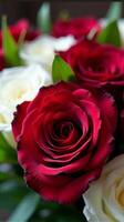 Dense Bouquet Featuring a Vibrant Contrast of Red and White Roses, With Lush Green Leaves Peeking Through the Petals photo