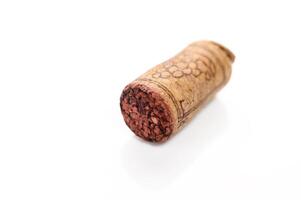 Blank wine cork isolated on white background close up photo