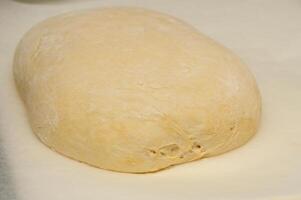 Ball of raw dough isolated on white background photo