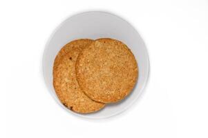 Stack of round biscuit cookies isolated on white background photo
