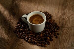 Cup of coffee and beans on a table. photo