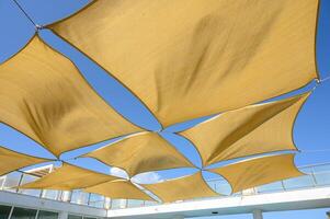 canvas sunshades over the pool Multiple large summer nylon patio sun shade umbrellas photo