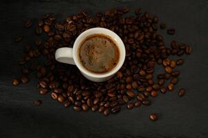Close-up of coffee cup with beans on table photo